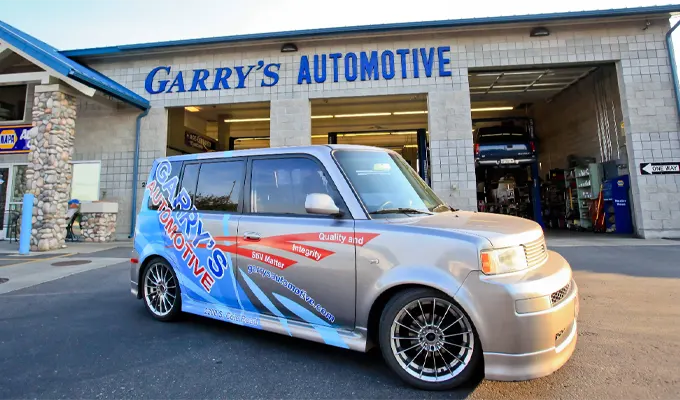 Garry’s Automotive Shop Front With Silver Car