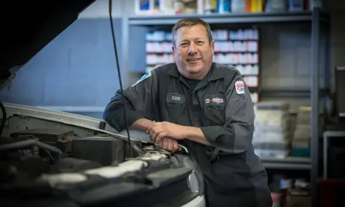 Smiling Mechanic With Tools