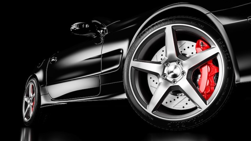 Black luxury car in studio lighting. Closeup wheel shot. 3d render