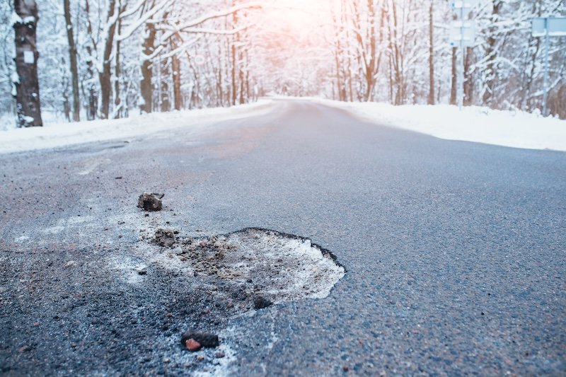 Poor road repairs - chunks of asphalt fall out in winter from cold and moisture suspension