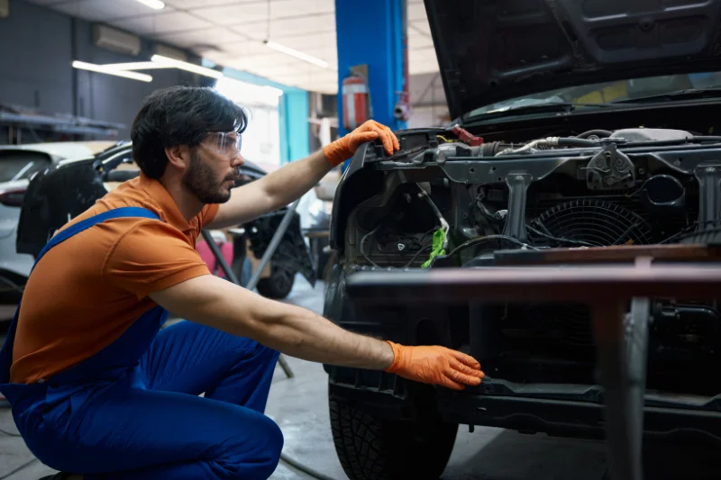 Mechanic repairing front car