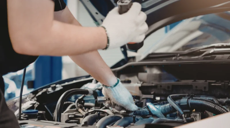 Mechanic performing a diagnostic check on a car