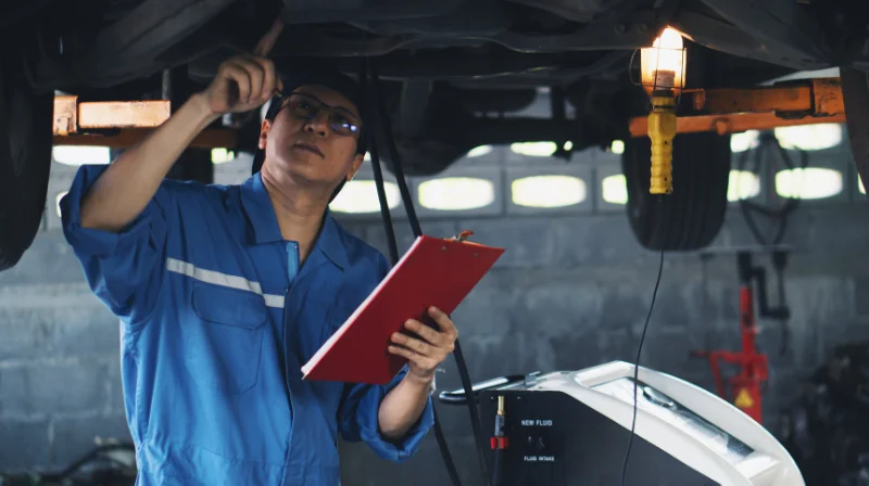 mechanic performing vehicle diagnostic check
