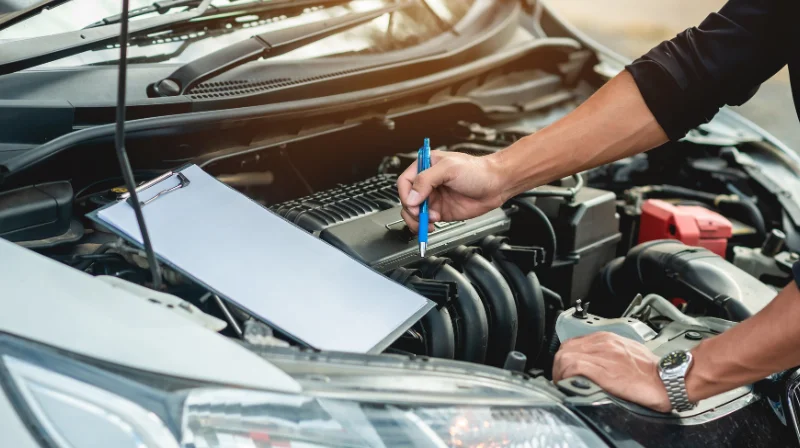 technician checking car electronics system